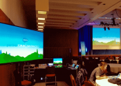 Indoor AV setup with screens, computer monitors, control systems, sound, display and stage lighting in Mission Bay Conference Center, San Francisco.