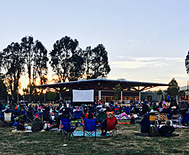 large audience waiting for outdoor movie to begin in south san francisco.