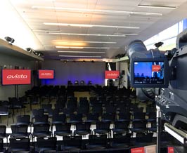 Large conference room with webcasting screens, cameras and equipment.